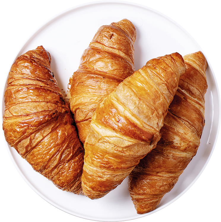 Imagen de unos croissants sobre un plato blanco
